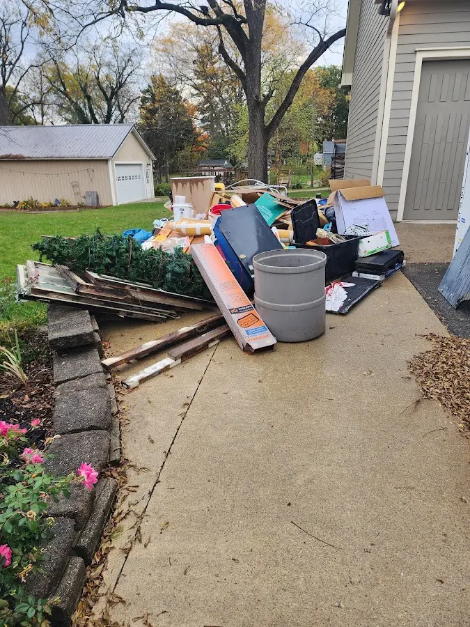 Dumpster being loaded with debris for Roofing Dumpster Rental in New Hyde Park